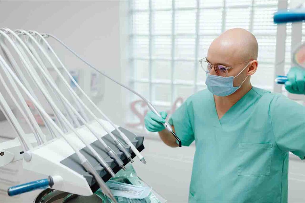 Expert dentist meticulously inspecting tools for optimal care and precision