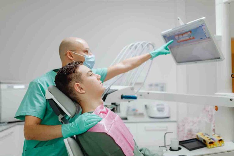 Patient happily examining their results with the dentist.