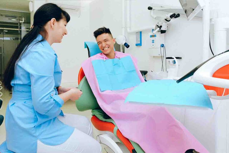 Patient smiling confidently with their dentist at the clinic