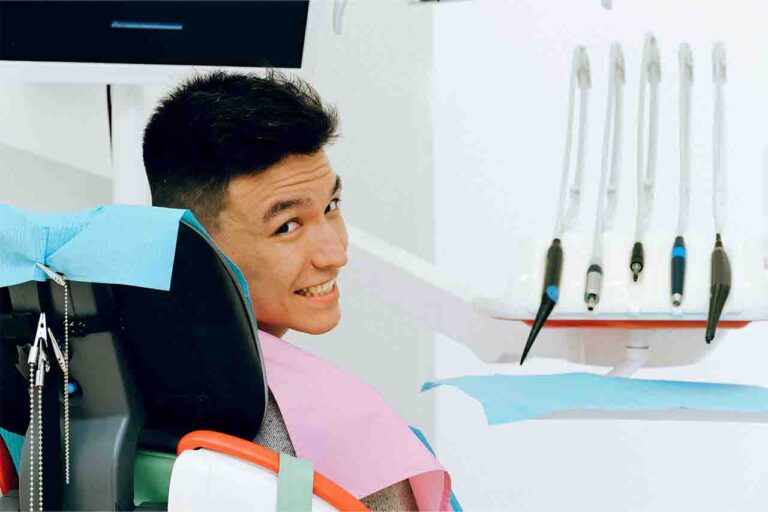 Happy patient smiling with dentist in the clinic